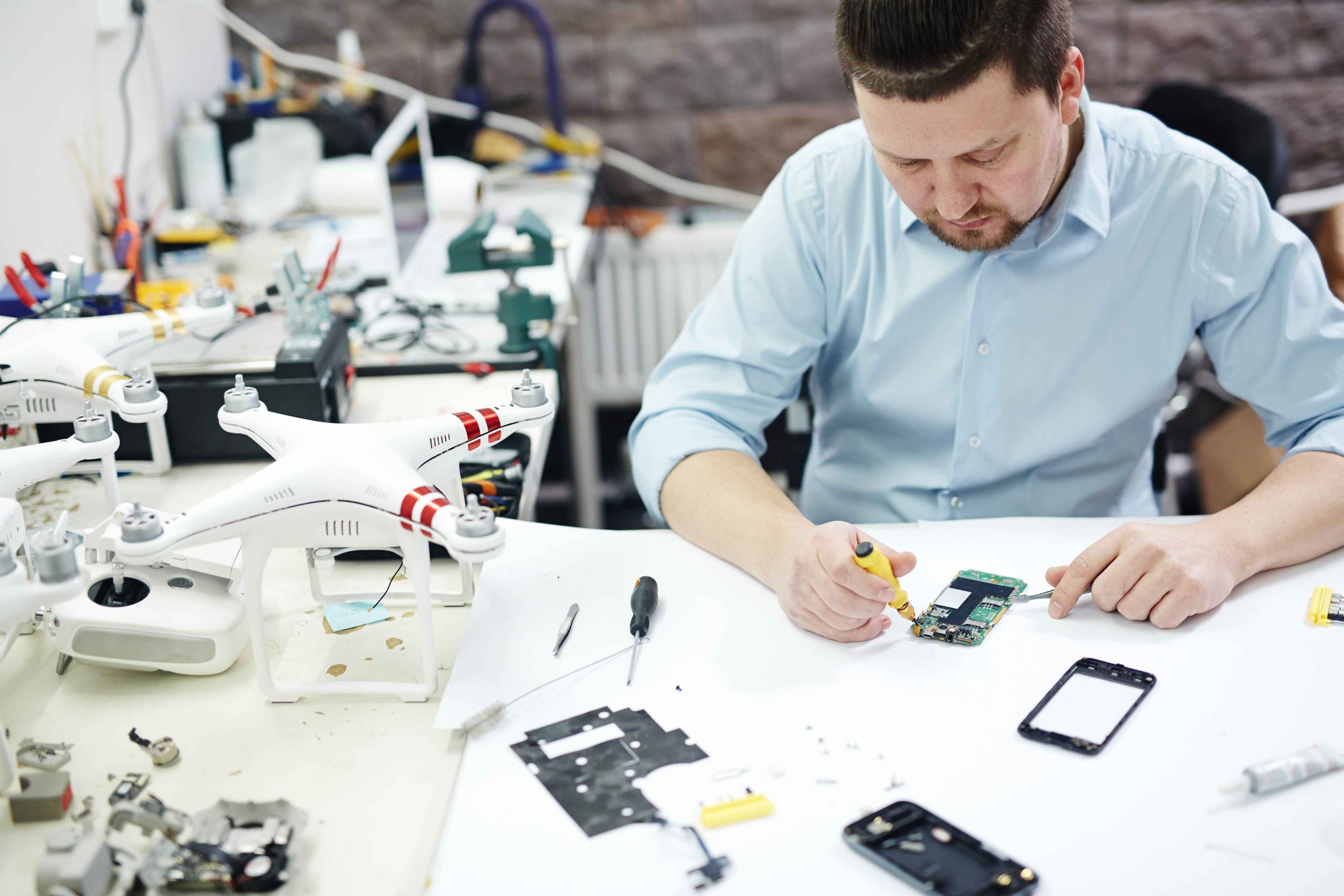 modern-man-working-electronics-service-shop-scaled.jpg